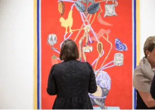 woman in museum looking at artwork